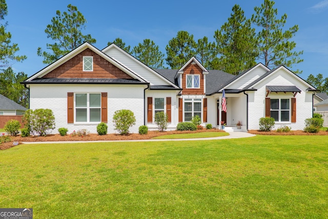 7270 Tillman Branch Rd, Hahira, GA 31632 - view of front of property with a front yard, brick siding, and a standing seam roof