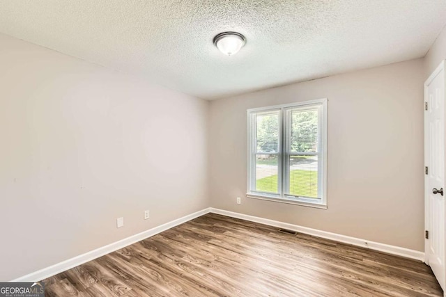 11473 Summer Creek Dr, Hampton, GA 30228 - unfurnished room featuring wood finished floors and a textured ceiling