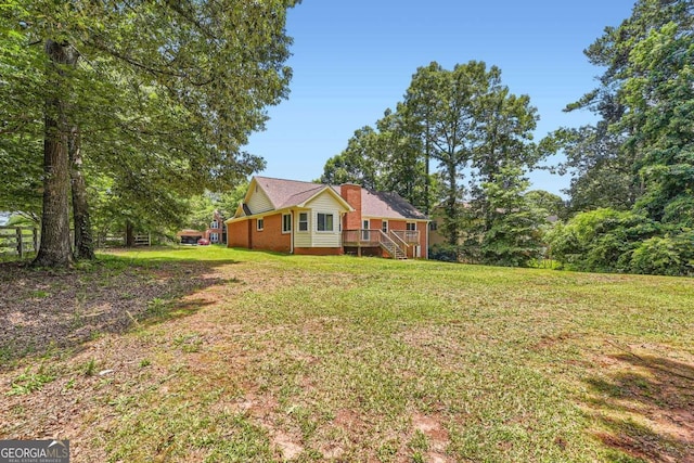 11473 Summer Creek Dr, Hampton, GA 30228 - view of grassy yard featuring stairs and a wooden deck