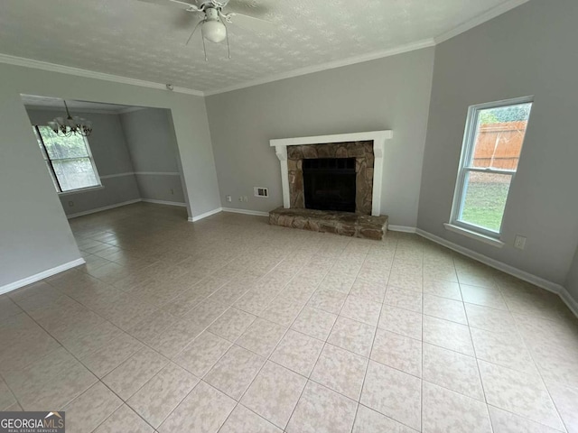 1081 Forest Path, Stone Mountain, GA 30088 - unfurnished living room featuring healthy amount of natural light, a chandelier, a ceiling fan, a stone fireplace, and crown molding
