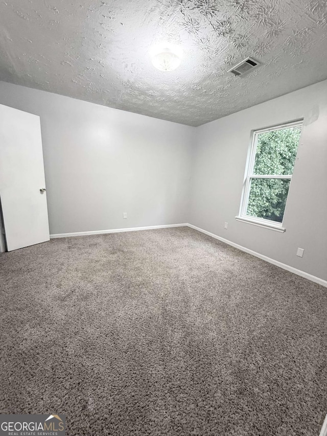1081 Forest Path, Stone Mountain, GA 30088 - carpeted spare room featuring a textured ceiling and baseboards