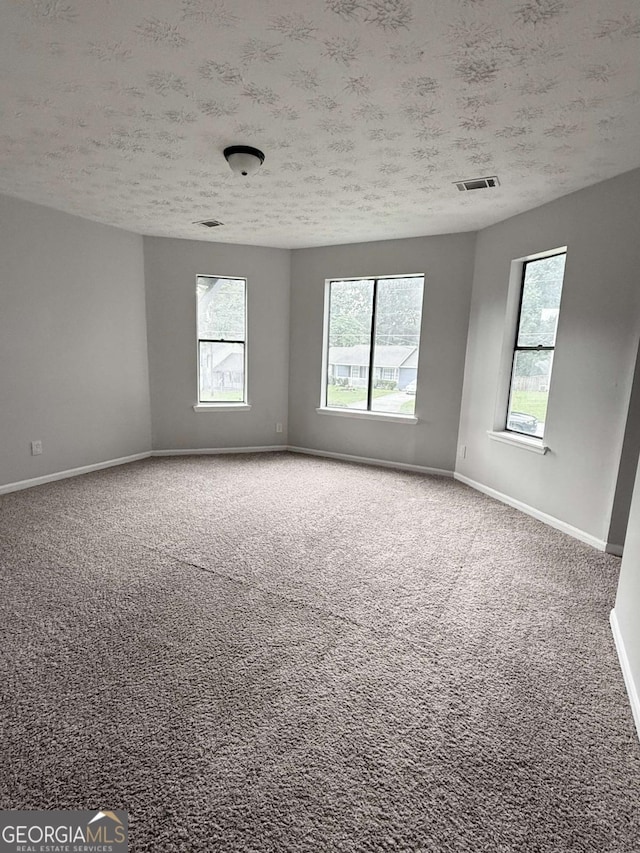 1081 Forest Path, Stone Mountain, GA 30088 - carpeted empty room with a textured ceiling and plenty of natural light