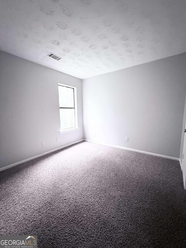 1081 Forest Path, Stone Mountain, GA 30088 - carpeted spare room featuring baseboards and a textured ceiling