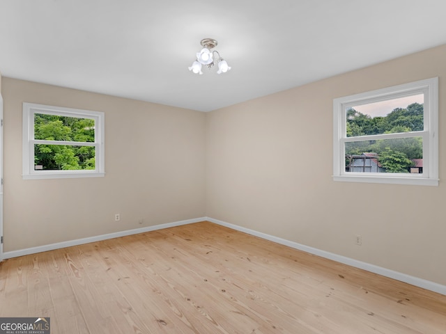 778 Leguin Mill Rd, Locust Grove, GA 30248 - empty room featuring wood finished floors and a chandelier