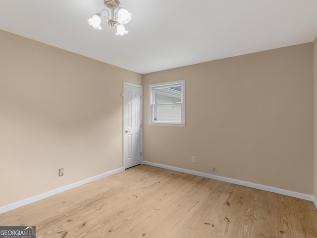 778 Leguin Mill Rd, Locust Grove, GA 30248 - spare room with a chandelier and light wood-style flooring