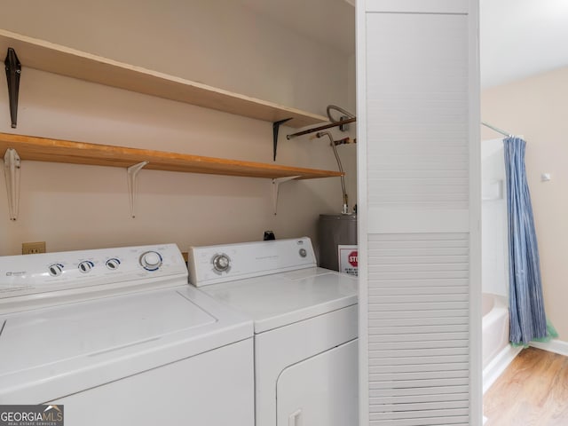 778 Leguin Mill Rd, Locust Grove, GA 30248 - laundry room with washer and dryer, water heater, and light wood-style flooring