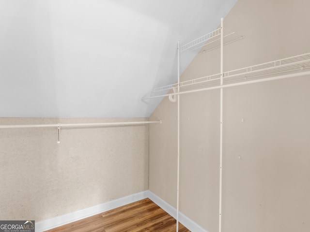 778 Leguin Mill Rd, Locust Grove, GA 30248 - spacious closet with lofted ceiling and wood finished floors
