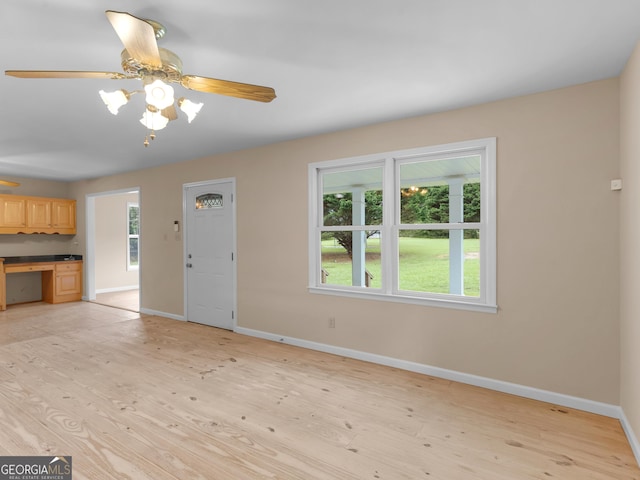 778 Leguin Mill Rd, Locust Grove, GA 30248 - unfurnished living room with light wood finished floors and ceiling fan