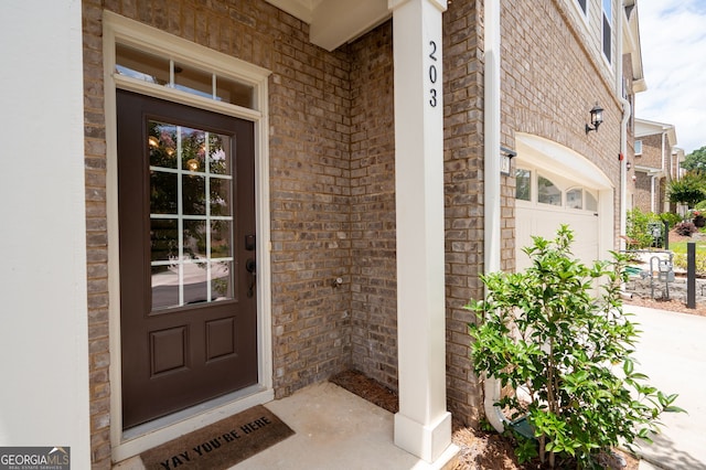 203 Holden Way, Woodstock, GA 30189 - view of exterior entry with brick siding and a porch