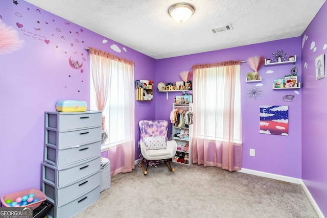 1147 Dunivin Dr, Jonesboro, GA 30238 - living area featuring carpet and a textured ceiling