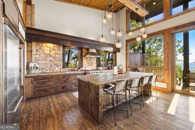126 Wawayanda Dr, Mineral Bluff, GA 30559 - kitchen with wall chimney exhaust hood, dark wood-style floors, a high ceiling, a wooden ceiling with exposed beams, and a center island with sink