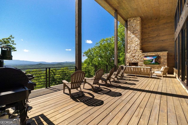 126 Wawayanda Dr, Mineral Bluff, GA 30559 - wooden deck with an outdoor stone fireplace and a mountain view