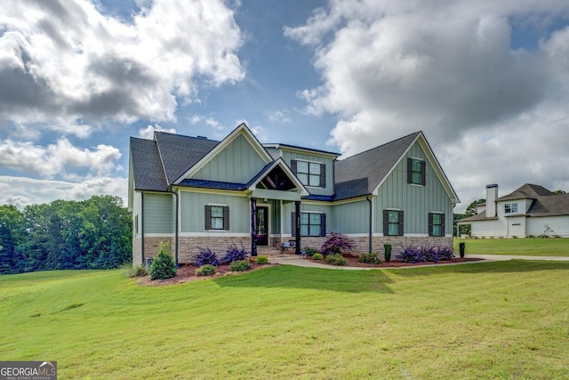 3076 E Lake Rd, Mcdonough, GA 30252 - craftsman house with board and batten siding, stone siding, a front yard, and a shingled roof