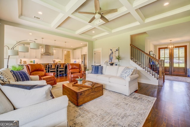 3076 E Lake Rd, Mcdonough, GA 30252 - living area featuring dark wood finished floors, stairs, coffered ceiling, a ceiling fan, and beam ceiling