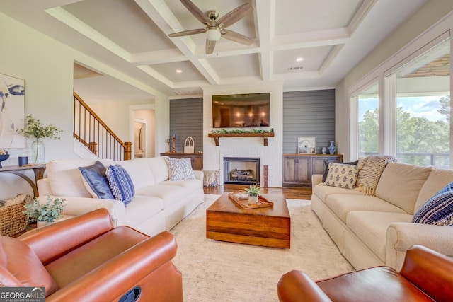 3076 E Lake Rd, Mcdonough, GA 30252 - living area with ceiling fan, coffered ceiling, stairs, beam ceiling, and a large fireplace