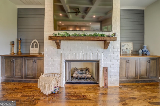 3076 E Lake Rd, Mcdonough, GA 30252 - detailed view of a fireplace, wood finished floors, coffered ceiling, wood walls, and beamed ceiling