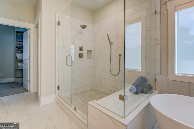 3076 E Lake Rd, Mcdonough, GA 30252 - full bath with a soaking tub, a shower stall, and healthy amount of natural light