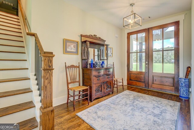 3076 E Lake Rd, Mcdonough, GA 30252 - entrance foyer featuring french doors, stairs, a chandelier, and wood finished floors