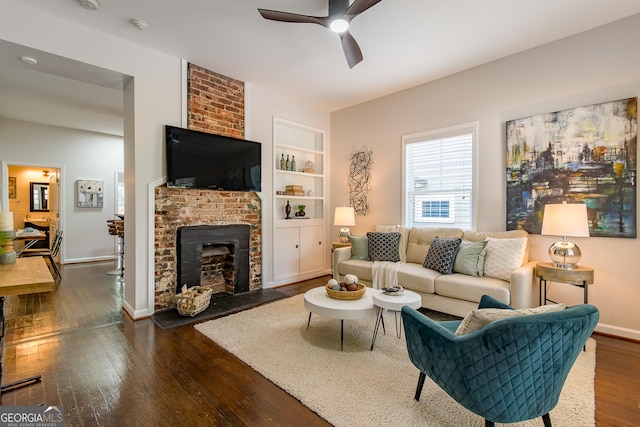 496 Rankin St NE, Atlanta, GA 30308 - living room featuring ceiling fan, dark wood-style flooring, a brick fireplace, and built in shelves