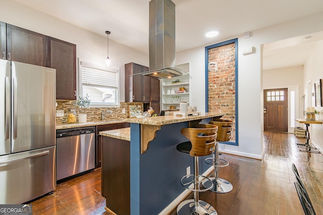 496 Rankin St NE, Atlanta, GA 30308 - kitchen featuring appliances with stainless steel finishes, island exhaust hood, a breakfast bar area, and healthy amount of natural light