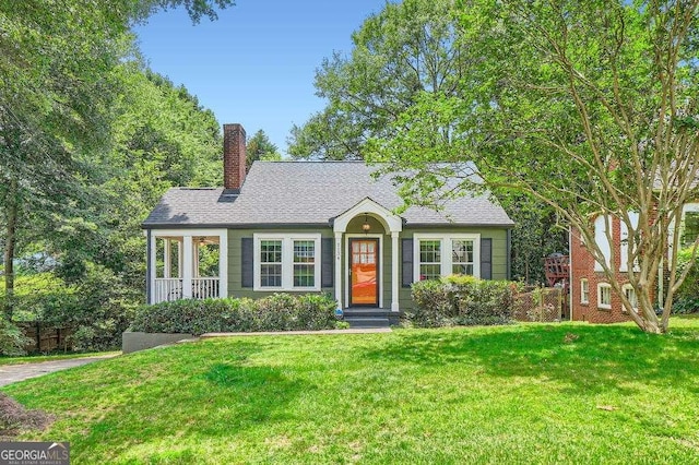 1134 Jefferson Ave, East Point, GA 30344 - view of front of property with a front yard, a chimney, and roof with shingles