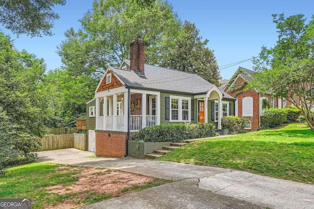 1134 Jefferson Ave, East Point, GA 30344 - view of front of house with a chimney and covered porch