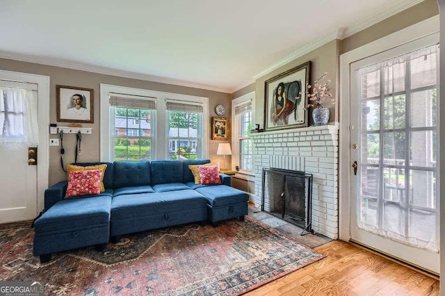 1134 Jefferson Ave, East Point, GA 30344 - living area with wood finished floors, crown molding, and a brick fireplace