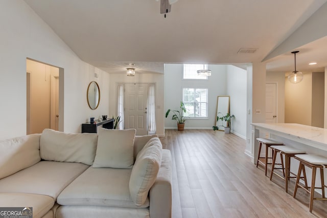 1406 Marshview Ct, Hoschton, GA 30548 - living room featuring lofted ceiling and light wood-style flooring