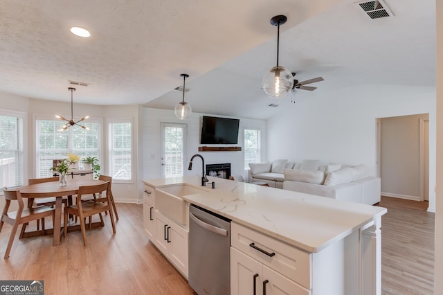 1406 Marshview Ct, Hoschton, GA 30548 - kitchen with stainless steel dishwasher, a large fireplace, ceiling fan, open floor plan, and light wood-style floors