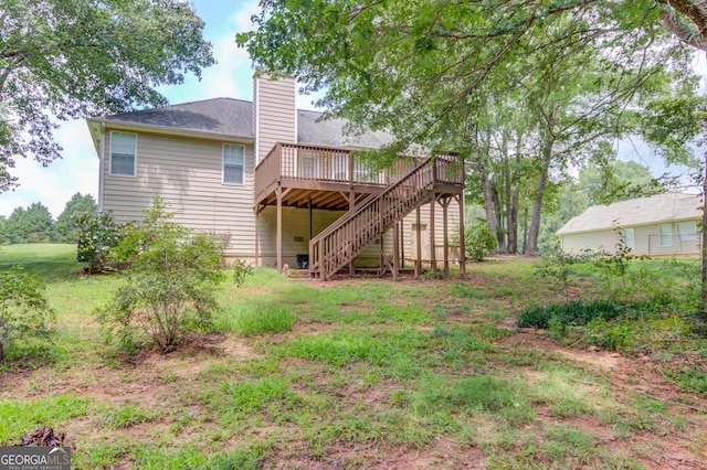 1406 Marshview Ct, Hoschton, GA 30548 - back of property with a deck, stairway, a chimney, and a shingled roof