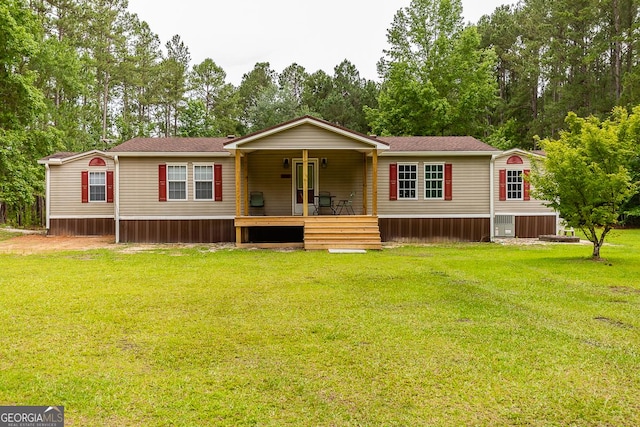 1185 Mp Martin Rd, Brooklet, GA 30415 - manufactured / mobile home featuring a front lawn, covered porch, and view of scattered trees