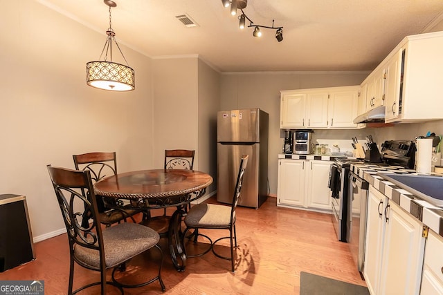 1185 Mp Martin Rd, Brooklet, GA 30415 - kitchen with freestanding refrigerator, under cabinet range hood, white cabinets, light wood-style flooring, and range with electric cooktop