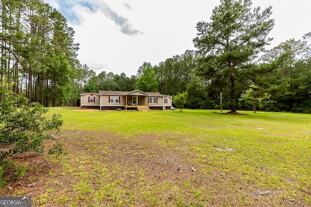 1185 Mp Martin Rd, Brooklet, GA 30415 - view of front of home with a front lawn and view of scattered trees