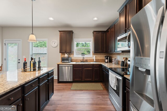 1001 Hartwell Rd, Locust Grove, GA 30248 - kitchen featuring appliances with stainless steel finishes, healthy amount of natural light, light wood-style flooring, dark brown cabinets, and recessed lighting
