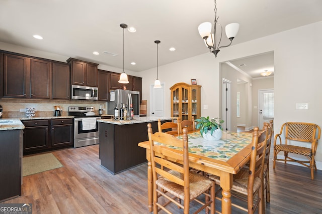 1001 Hartwell Rd, Locust Grove, GA 30248 - dining room with wood finished floors, recessed lighting, and a chandelier
