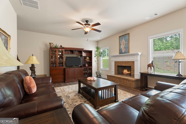 1001 Hartwell Rd, Locust Grove, GA 30248 - living area with wood finished floors, a ceiling fan, and a brick fireplace
