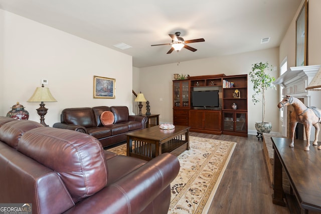 1001 Hartwell Rd, Locust Grove, GA 30248 - living area featuring ceiling fan, dark wood finished floors, and a stone fireplace
