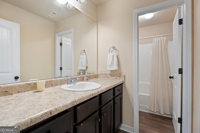 1001 Hartwell Rd, Locust Grove, GA 30248 - bathroom featuring vanity, wood finished floors, and shower / tub combo