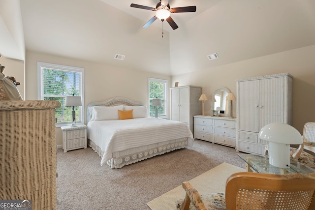 1001 Hartwell Rd, Locust Grove, GA 30248 - bedroom featuring multiple windows, vaulted ceiling, light colored carpet, and ceiling fan