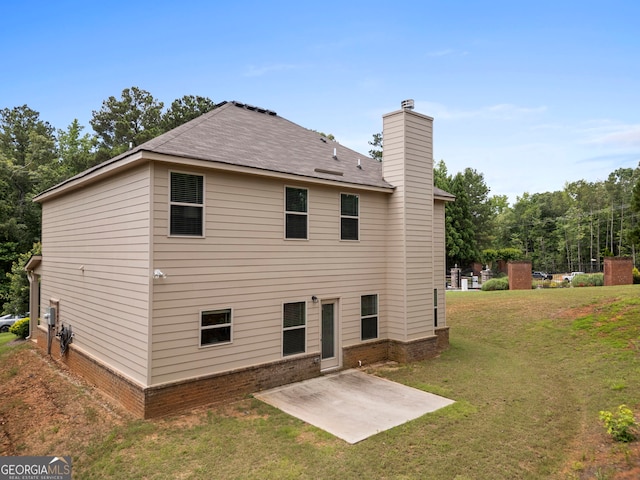 1001 Hartwell Rd, Locust Grove, GA 30248 - rear view of house with a patio, a chimney, and a lawn