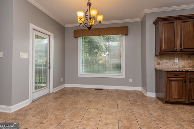 303 Sage Meadows Ln, Bonaire, GA 31005 - unfurnished dining area with a chandelier, ornamental molding, and light tile patterned flooring