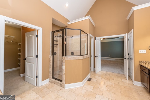 303 Sage Meadows Ln, Bonaire, GA 31005 - bathroom featuring a stall shower, a walk in closet, vanity, and lofted ceiling