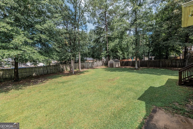 303 Sage Meadows Ln, Bonaire, GA 31005 - fenced backyard featuring a storage shed