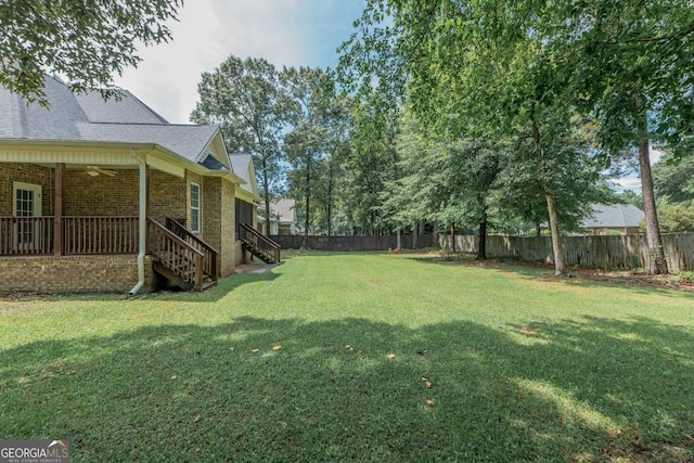 303 Sage Meadows Ln, Bonaire, GA 31005 - fenced backyard featuring a ceiling fan and stairs