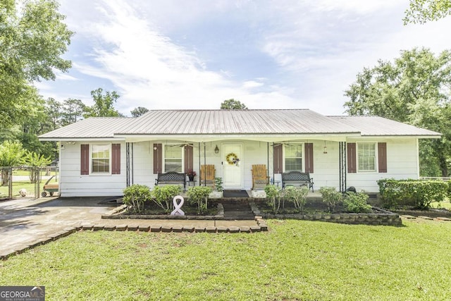 4782 Two Oak Dr, Macon, GA 31210 - view of front of home with covered porch, a front lawn, and a metal roof