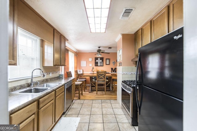 4782 Two Oak Dr, Macon, GA 31210 - kitchen with appliances with stainless steel finishes, brown cabinetry, ornamental molding, ceiling fan, and light tile patterned floors