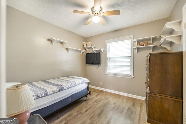 4782 Two Oak Dr, Macon, GA 31210 - bedroom with a textured ceiling, light wood-style flooring, and ceiling fan