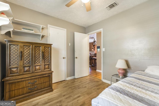 4782 Two Oak Dr, Macon, GA 31210 - bedroom featuring wood finished floors, a textured ceiling, and a ceiling fan