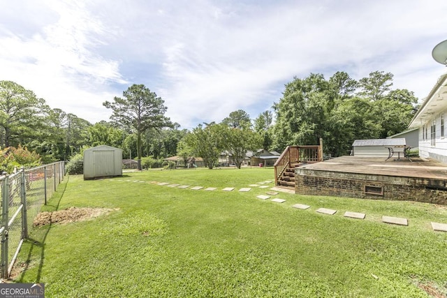 4782 Two Oak Dr, Macon, GA 31210 - view of yard with a storage unit, a wooden deck, and view of wooded area