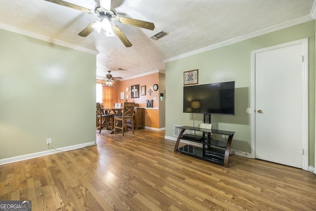 4782 Two Oak Dr, Macon, GA 31210 - living room featuring a ceiling fan, wood finished floors, a textured ceiling, and crown molding